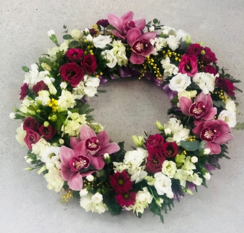 A circle of rich pink and reds including white Eustoma