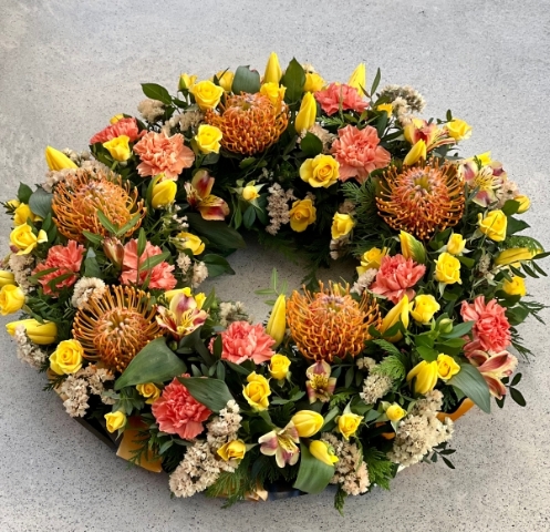 A selection of golden, yellow and cream tones designed onto a bed of seasonal foliage